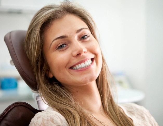 Smiling woman in dental chair at modern dentistry office